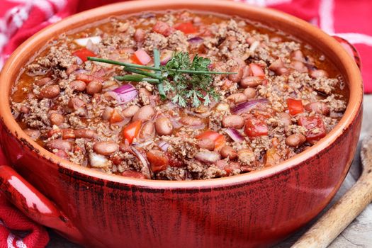 Chili Con Carne in a red ceramic pot. 