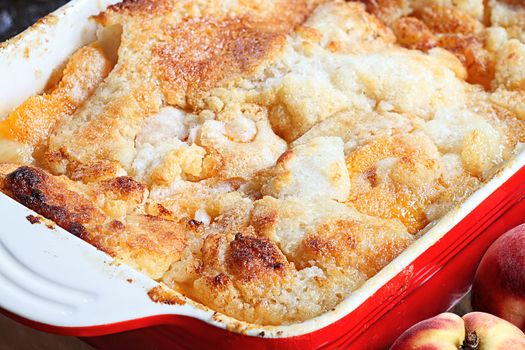 Freshly baked peach cobbler with shallow depth of field.