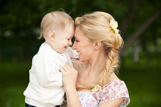 Happy blonde mom and son outdoors