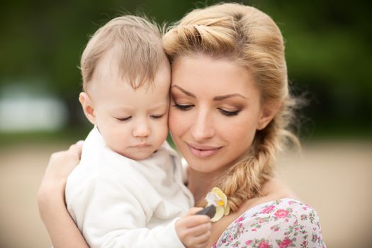 mother is teaching her baby son to get to know the world