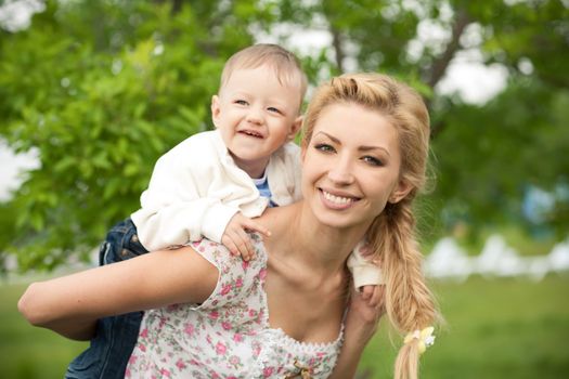 Happy blonde mom and son outdoors