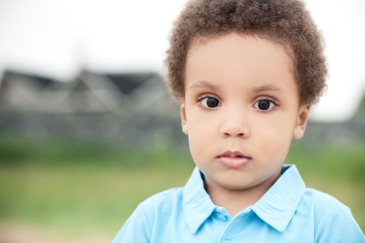 cute african american boy on a background of green grass