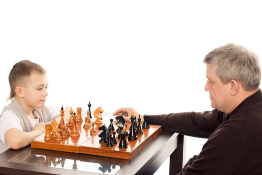 Grandfather and Grandson having a game of chess on a white background