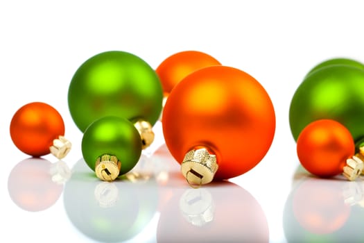 Christmas ornaments - orange and green, on a white background with copy space
