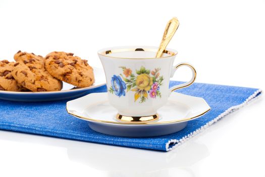 Chocolate chip cookies and cup of tea on white background