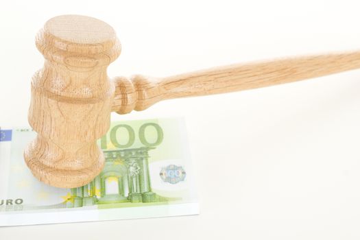Gavel made of oak wood with some money