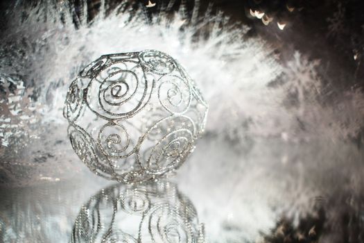 Silver christmas ball with shiny decorationand stars