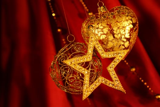 Golden christmas decoration on red fabric background