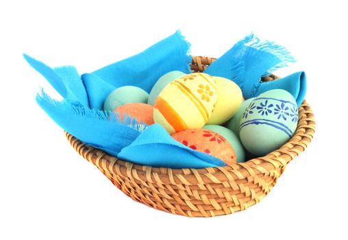 Basket of colored easter eggs in basket on white background