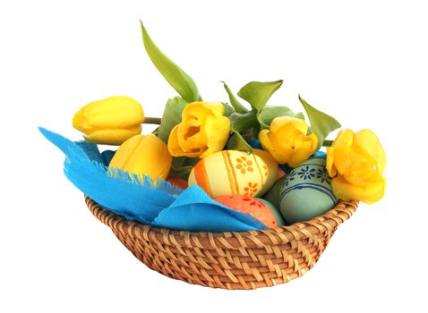 Basket of colored easter eggs and tulips on white background