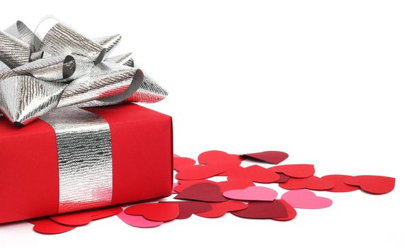 Valentines Day gift in red box and small hearts isolated on white