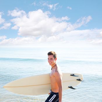 Surfer handsome boy teenager with surfboard in beach shore