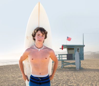 Surfer boy teenager with surfboard in Santa Monica Lifeguard house California