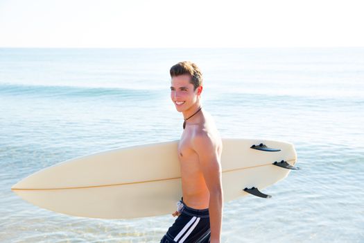 Surfer handsome boy teenager with surfboard in beach shore