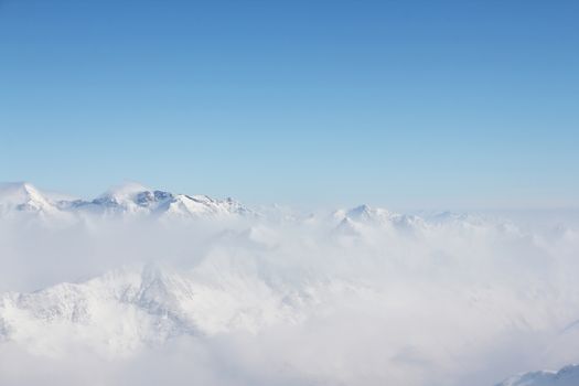 Mountain peaks of winter alps under blue sky