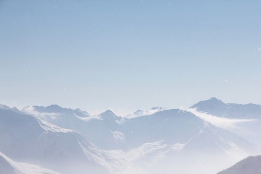 Mountain peaks of winter alps under blue sky