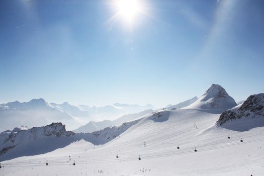 Mountain peaks of winter alps under blue sky