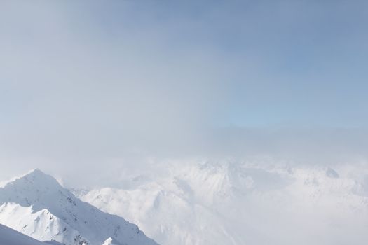 Mountain peaks of winter alps under blue sky