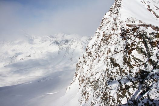 Mountain peaks of winter alps under blue sky