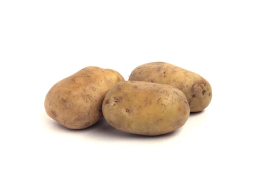 Three potatoes close up isolated on white background