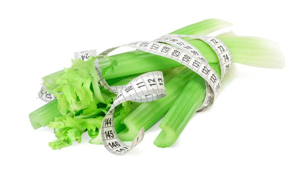 Celery and measure tape diet concept isolated on white