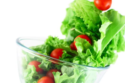  Light lettuce and cherry tomatoes salad close-up isolated on white lightness concept