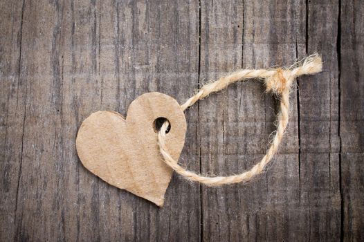 A Paper Heart Tag on wooden background