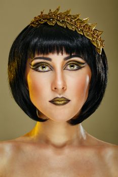 Close-up portrait of a beautiful girl with an evening make-up and jewelery