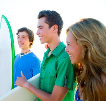 Teenager surfers group happy in beach shore high key