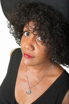Doubting Hispanic woman in hat on isolated background