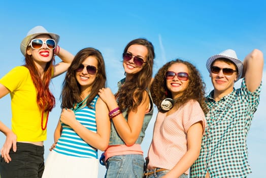 group of young people wearing sunglasses and hats hugging and standing in a row, spending time with friends