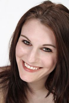 A close-up of a lovely young brunette with a bright, warm smile.