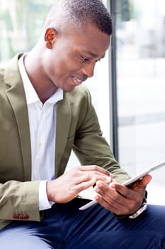smiling successful businessman with tablet pc outdoor in summer 