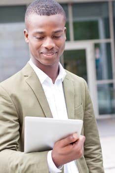 smiling successful businessman with tablet pc outdoor in summer 