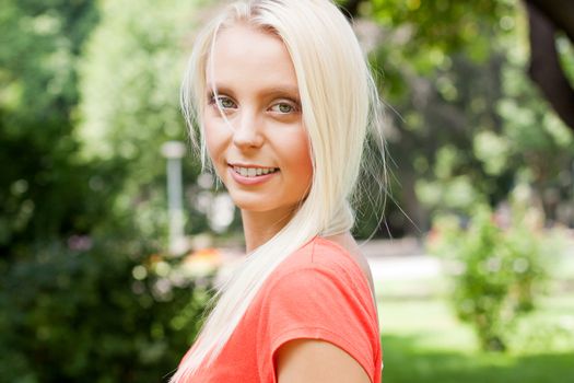 beautiful young blonde girl lying in grass summertime outdoor in park