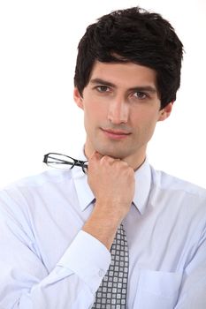 Businessman holding his eyeglasses