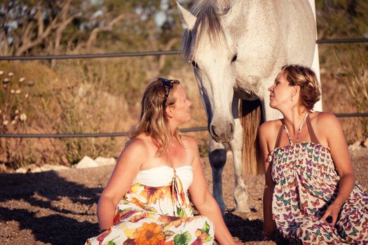 two woman horse and dog outdoor in summer happy sunset together nature