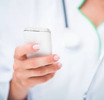 Doctor's hands with white mobile phome close up