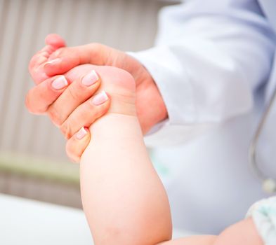 Mother makes baby a foot massage