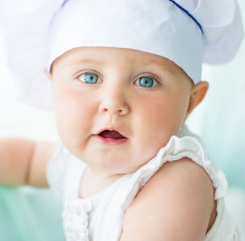 portrait of baby in chef's hat