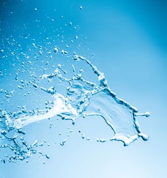 Drops and splashes of water on a blue background