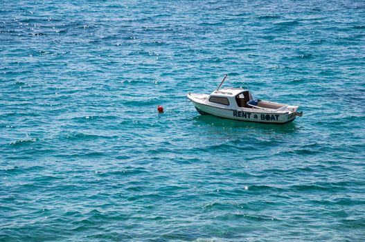 Boat for rent on a turquoise sea.