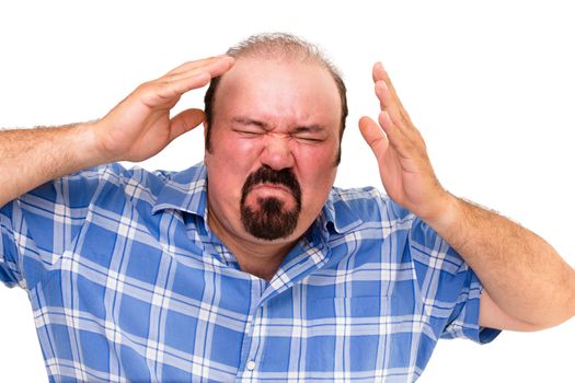 Enraged man with a flushed red face wringing his hands in frustration and anger as he grimaces in frustration, isolated on white