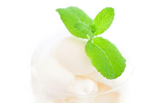 ice cream with mint in a glass bowl isolated on white