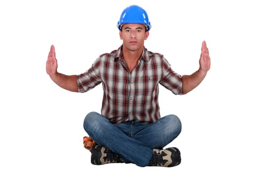 Austere tradesman leaning forward and holding up his arms