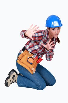 A scared female construction worker.