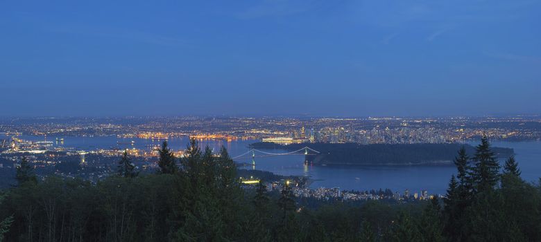 Vancouver BC Canada Cityscape with Stanley Park and Lions Gate Bridge Over Burrard Inlet at Evening Blue Hour Panorama