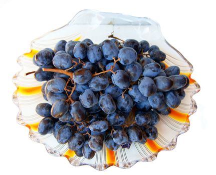 Ripe grape on plate on white background