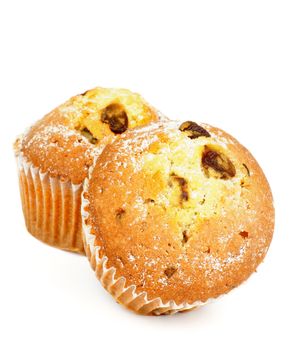 Two Delicious Homemade Muffins with Raisins and Sugar Powder isolated on white background