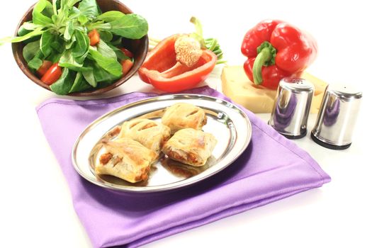 Puff pastry with bell peppers and cheese filling on a light background